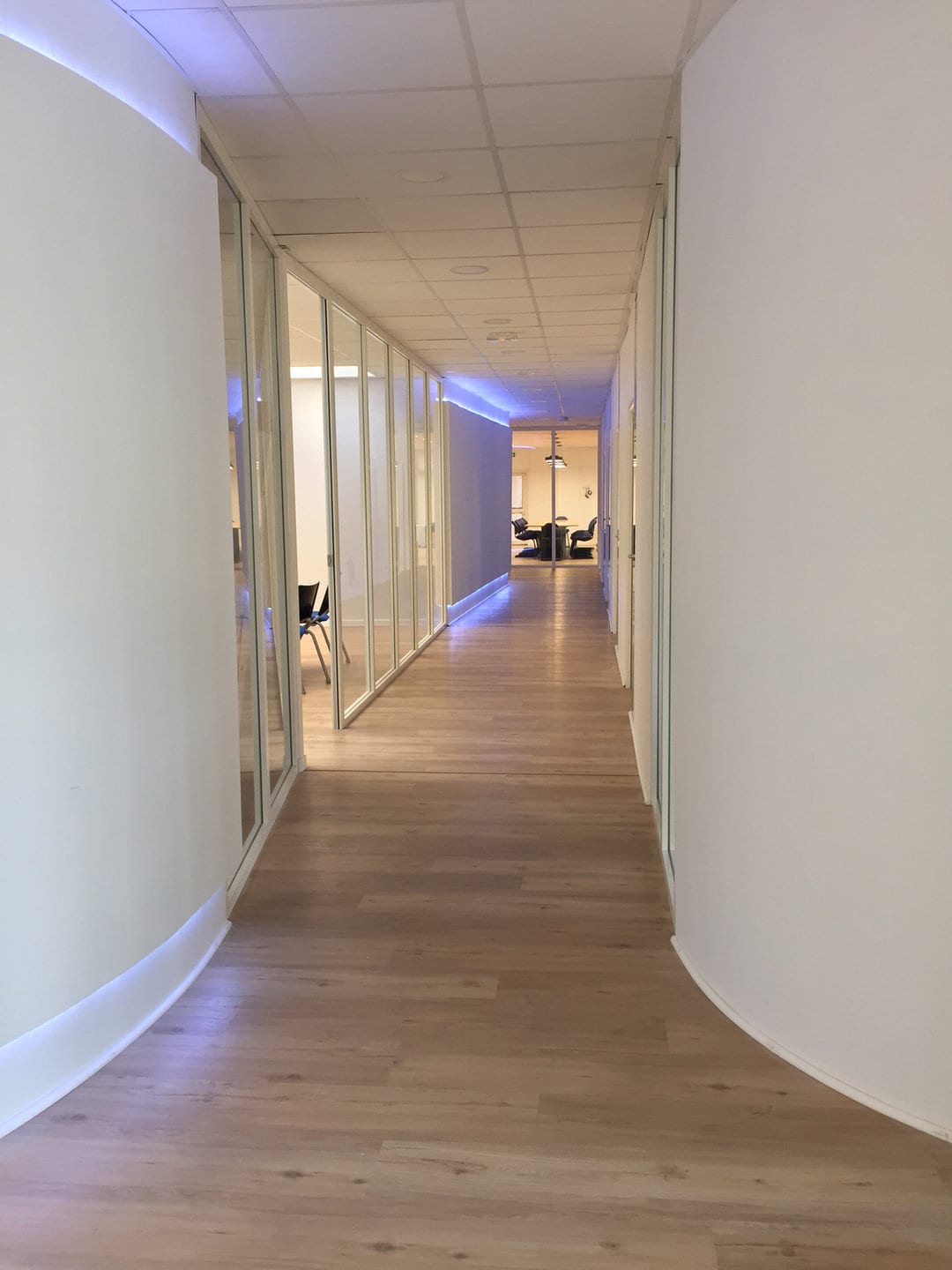 Curved corridor with glazed partitions